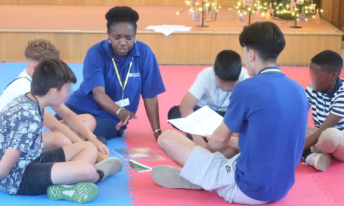 Annie sharing a story with children.